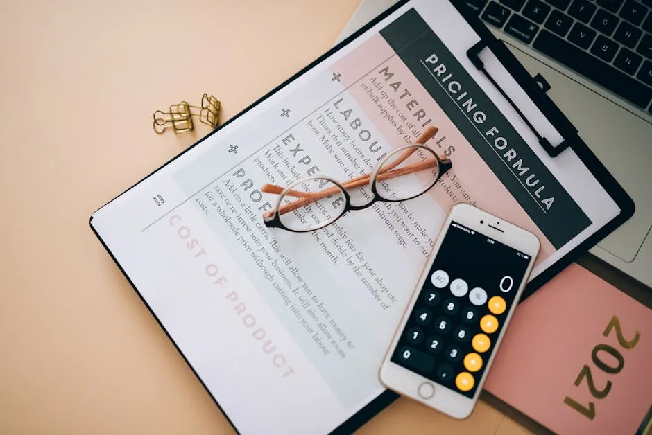 Overhead view of a calculator, notebook, and pricing formula document on a workspace.